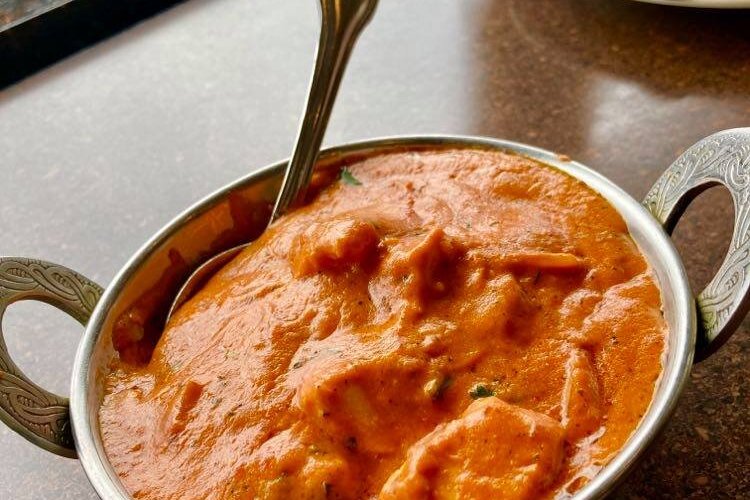 Chicken Tikki Masala - Sliced onions, tomatoes and bell peppers cooked in a tomato-based sauce.