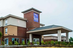 Sleep Inn & Suites Airport in DeWitt, image may contain: Hotel, Inn, Portico, Housing