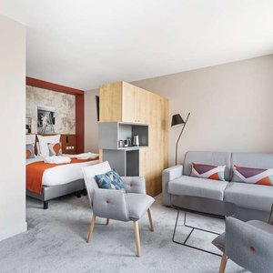 Family Guest Room with One Queen Size Bed and Double Sofabed in the Sitting Area