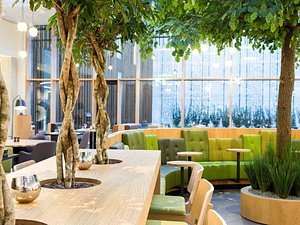 Novotel Amsterdam Schiphol Airport in Hoofddorp, image may contain: Indoors, Lounge, Restaurant, Potted Plant