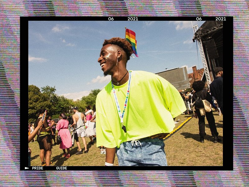 Young Black man in neon shirt with pride flag
