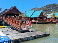 Saffron robe Buddhist monks visit Ko Panyi Muslim fishing village