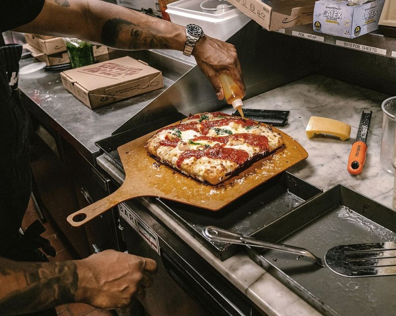 Pizza on a wooden board at Down North Pizza