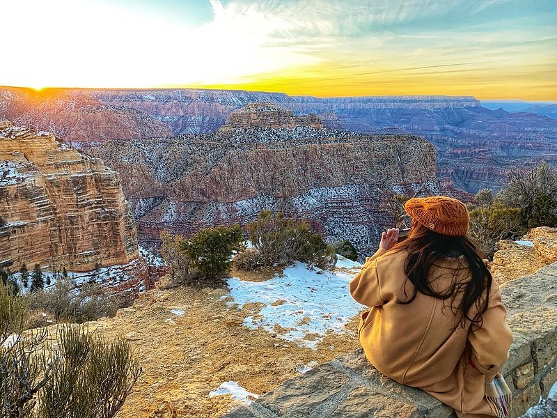 person looking out over the Grand Canyon at Sunset in winter