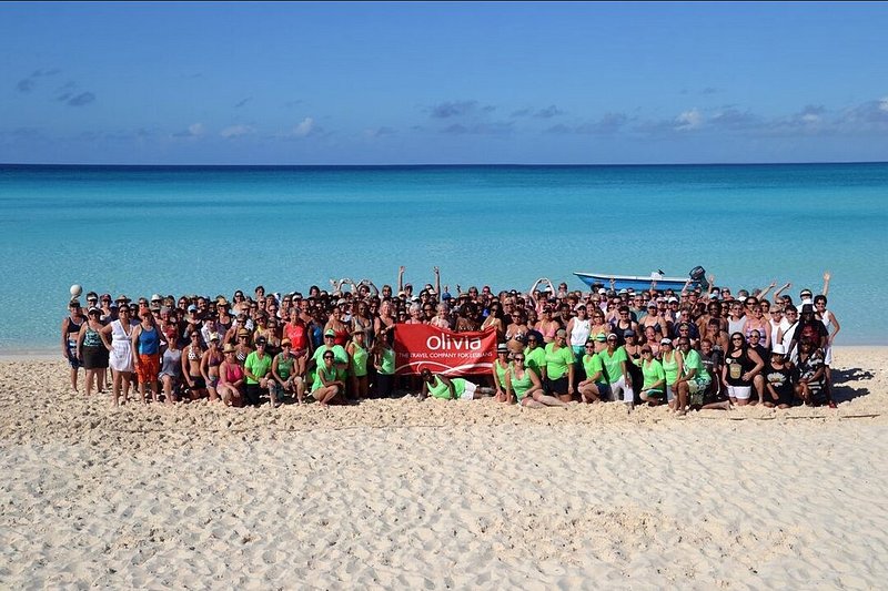 Group of women on beach traveling with Olivia