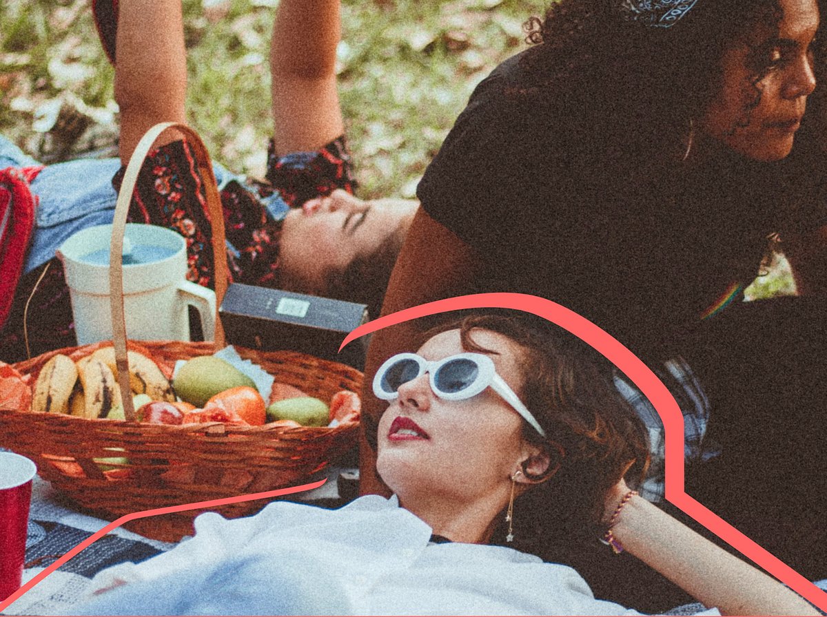 Young girls at laying on a picnic blanket
