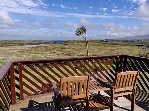 Orasay Inn in South Uist, image may contain: Balcony, Building, Chair, Furniture