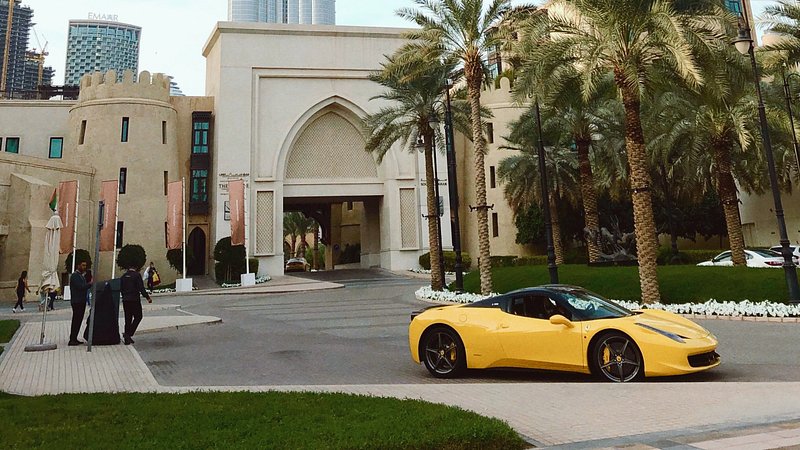 Luxury Ferrari sports car parked along a road in Dubai