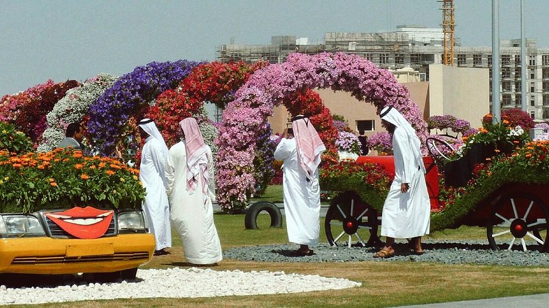 Visitors at a colorful flower display at the Dubai Miracle Garden