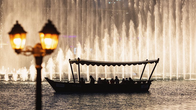 Travelers on a Dubai Fountain Lake Ride at night in Burj Khalifa Lake