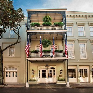 Bienville House in New Orleans, image may contain: City, Urban, Balcony, Flag