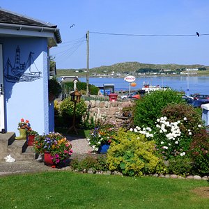 Side view of Seaview's front garden over looking the Sound of Iona with the Calmac ferry waiting at the pier. 