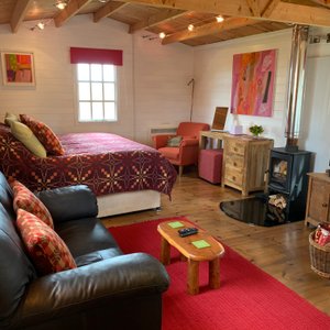 Open plan bedroom and sofa. Woodburner 