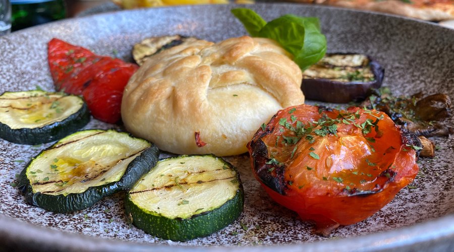 Goats cheese wrapped in pastry and served with a variety of grilled vegetables. 