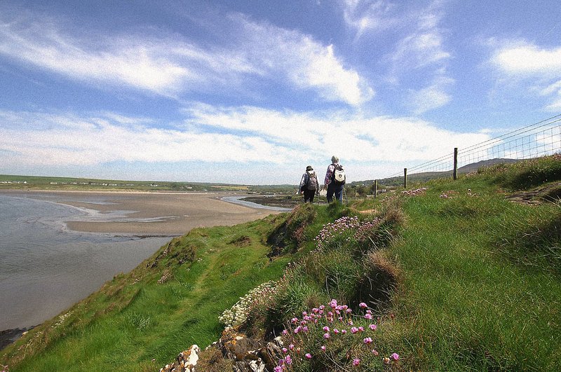 A couple walking along the Pembrokeshire Coast Path