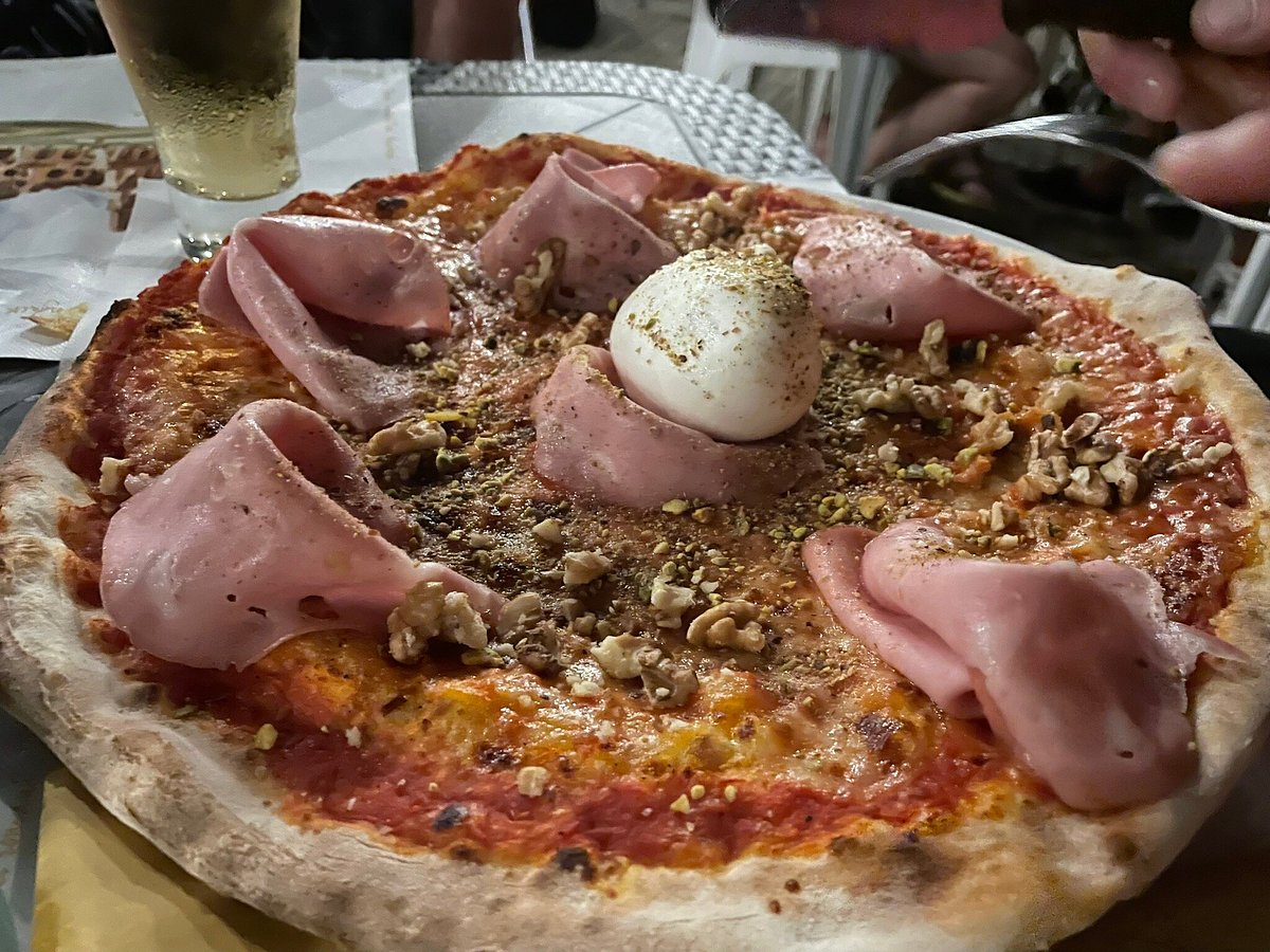 Antico tavolo da pranzo con pizza, insalata, stoviglie, palloncino