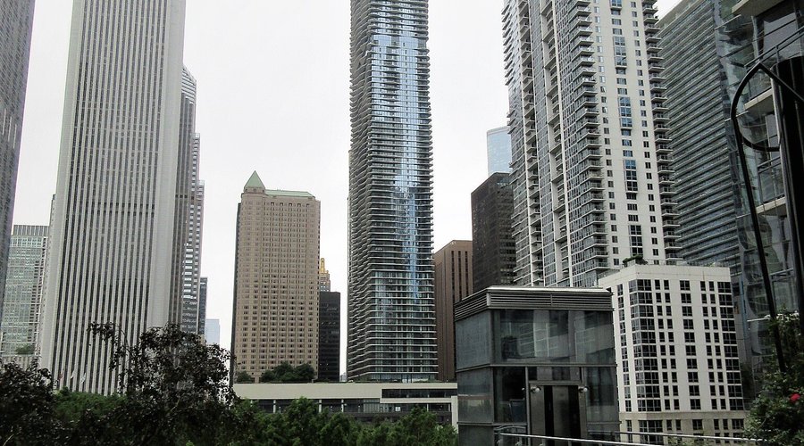Aqua Tower (built 2009), which is the location of offices, apartments, condos and Radisson Blu Aqua Hotel. View from the residential area at Lake Shore East Park. July 2021