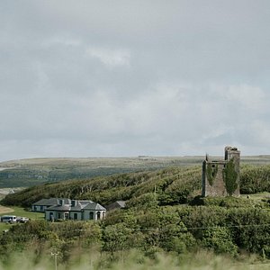 Ballinalacken Castle Country House in Doolin, image may contain: Cottage, Building, Land, Grass