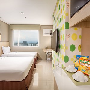 Injap Tower Hotel's Happy Room is complete with a queen size bed and a single bed set-up