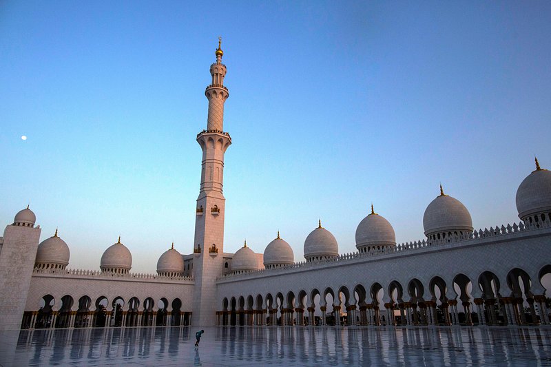 A boy jumps in the courtyard at the Sheikh Zayed Grand Mosque