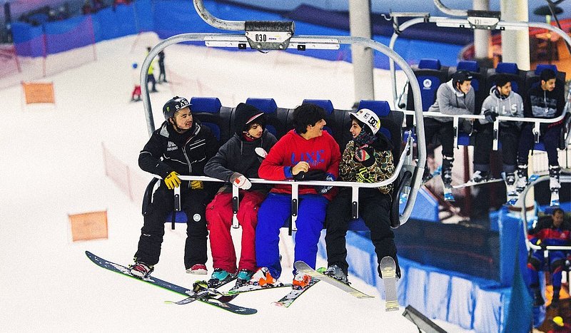 A group of friends on a ski lift at Ski Dubai