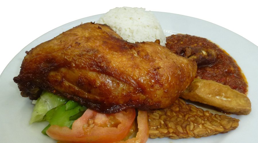Ayam Penyet with Special Sambal chilli sauce, serve with tempei, fried tofu nand boiled cabbage
