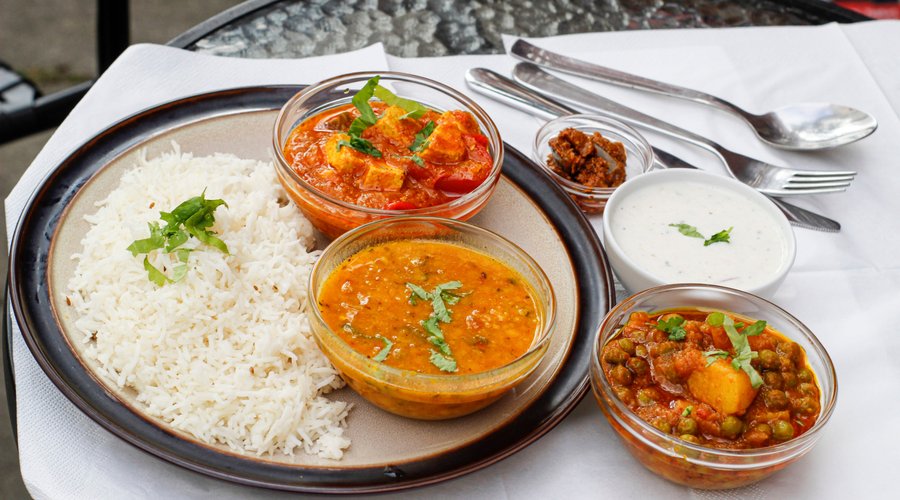 Paneer and mix veg curry. Indian vegetarian Thali combo served with bread and Mango Lassi 