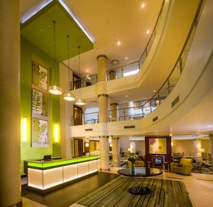 StayEasy Pietermaritzburg in Pietermaritzburg, image may contain: Lamp, Foyer, Indoors, Couch