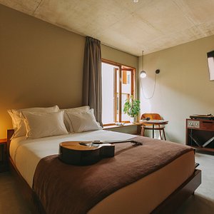 M.Ou.Co. Hotel in Porto, image may contain: Dorm Room, Bedroom, Guitar, Interior Design