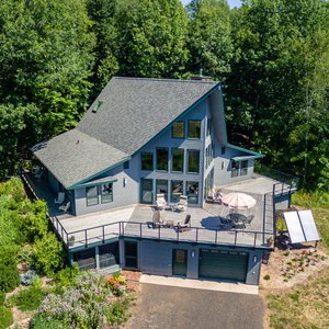 Two first floor guest rooms with two deck chairs and table on each side of Artesian House.