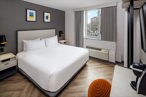 voco Times Square South New York, An IHG Hotel in New York City, image may contain: Furniture, Interior Design, Home Decor, Bed