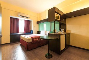 Microtel By Wyndham Batangas in Luzon, image may contain: Corner, Interior Design, Bedroom, Furniture