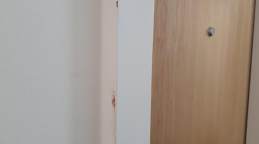 Blood stains on doorframe to apartment