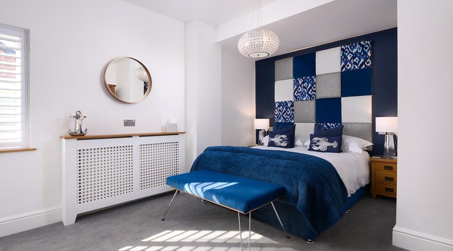 Room 3 - The Paignton Harbour Suite. The bedroom of this stunning sea-view Suite with balcony.