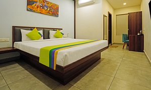 Treebo Trend Lazystay Grand Patia in Bhubaneswar, image may contain: Corner, Bed, Hotel, Flooring