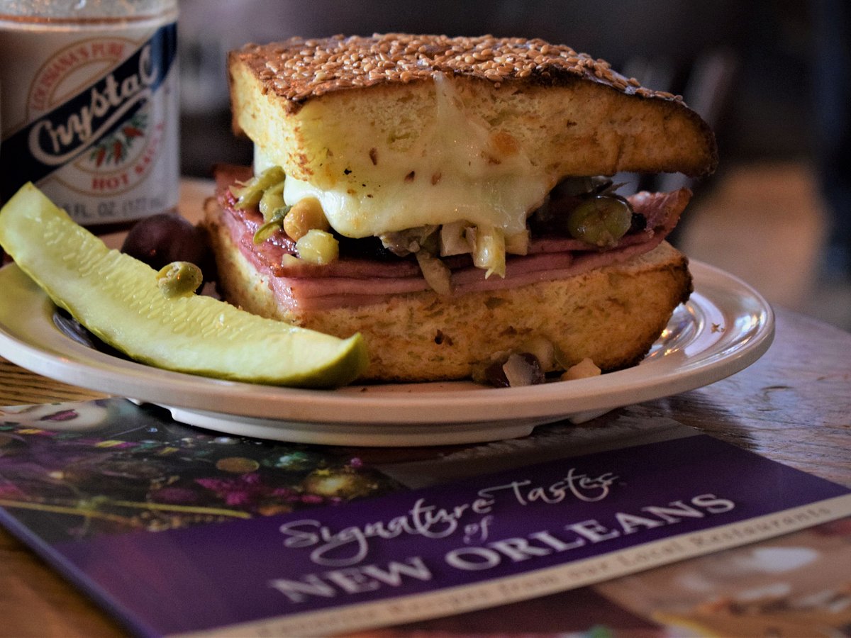 https://dynamic-media-cdn.tripadvisor.com/media/photo-o/21/5c/5d/09/enjoy-a-delicious-muffuletta.jpg?w=1200&h=900&s=1