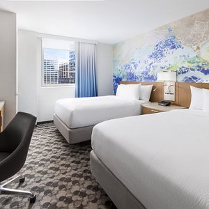 Our contemporary and refreshing 2 double bedded rooms feature 2 luxurious beds, a hybrid work/entertainment zone featuring a mini refrigerator, complimentary WiFi, complimentary in room coffee maker, and multiple plugs and USB ports for your charging needs. 