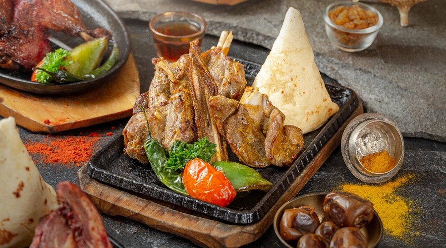 Roasted meat served with rateb bread, honey and tahina paste