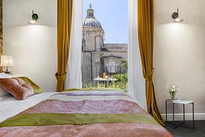 Relais Antica Badia - San Maurizio 1619 in Sicily, image may contain: Linen, Home Decor, Furniture, Bedroom