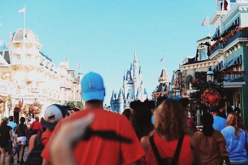 Tourists walk toward the castle at Walt Disney World Orlando