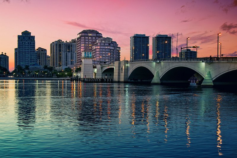 A pink sunset glows over downtown West Palm Beach