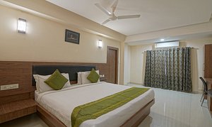 Treebo Trend Mvp Grand in Visakhapatnam, image may contain: Ceiling Fan, Electrical Device, Bed, Furniture