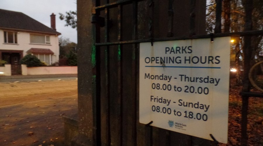 Opening hours sign on the gate.