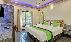 Treebo Trend Hotel Dreamworld in Bhose, image may contain: Interior Design, Bed, Monitor, Home Decor