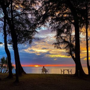 Enjoy your favorite food and drink at the beach while watching the sun set over the Andaman Sea