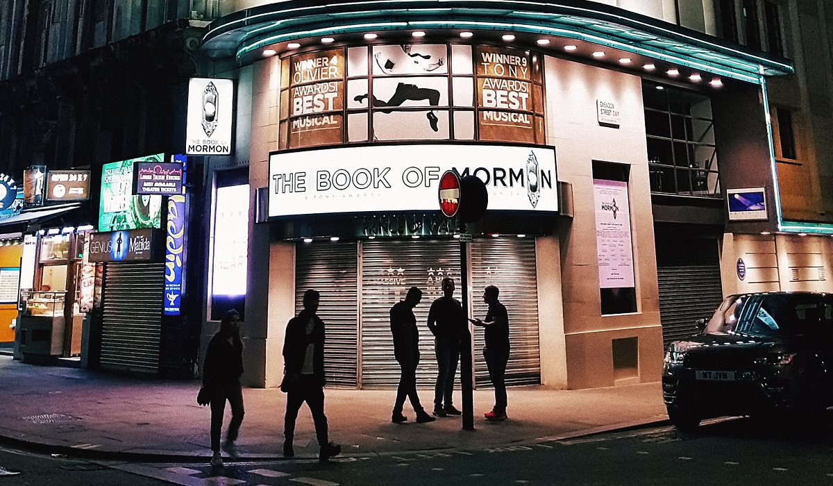 Outside the Book of Mormon theatre in London at night at the Prince of Wales theatre