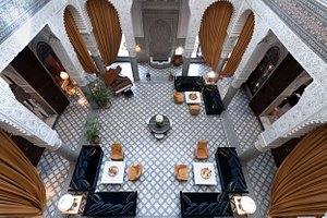 Riad Fes - Relais & Chateaux in Fes, image may contain: Indoors, Handbag, Dining Table, Dining Room