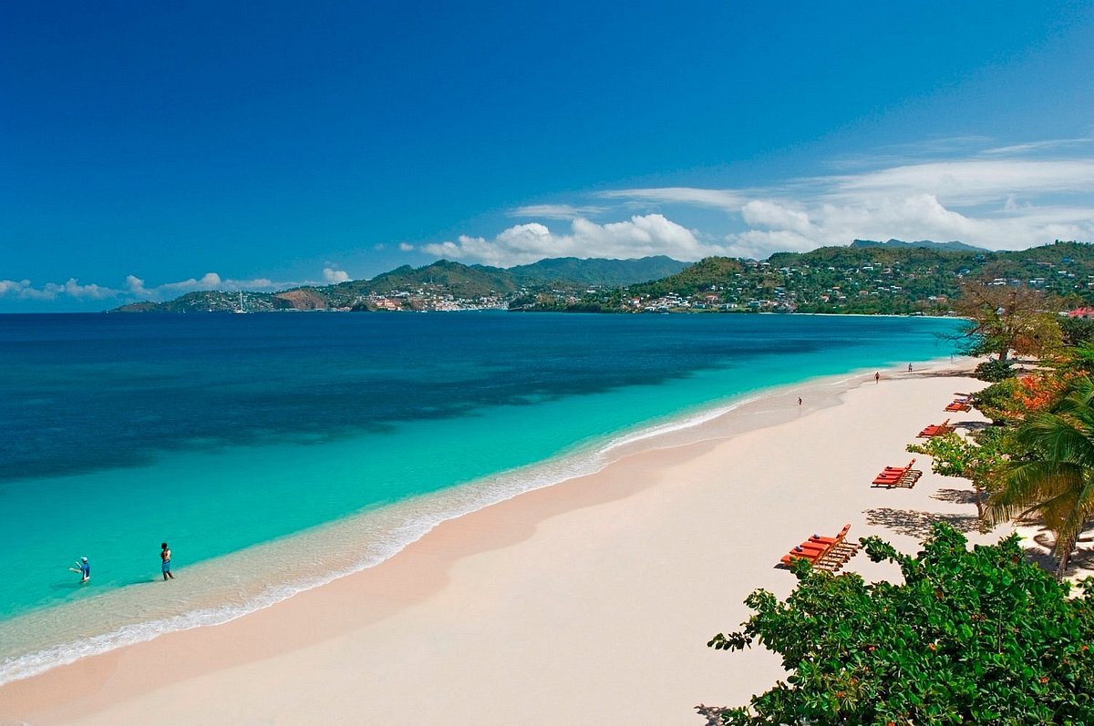Grand Anse Beach with turquoise waters and green hillsides in the distance