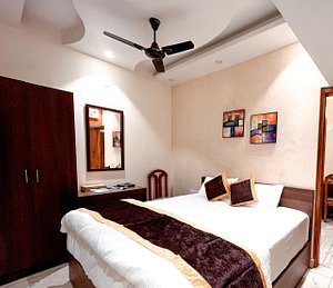 Hotel Joylife in Rohtak, image may contain: Ceiling Fan, Device, Bed, Chair