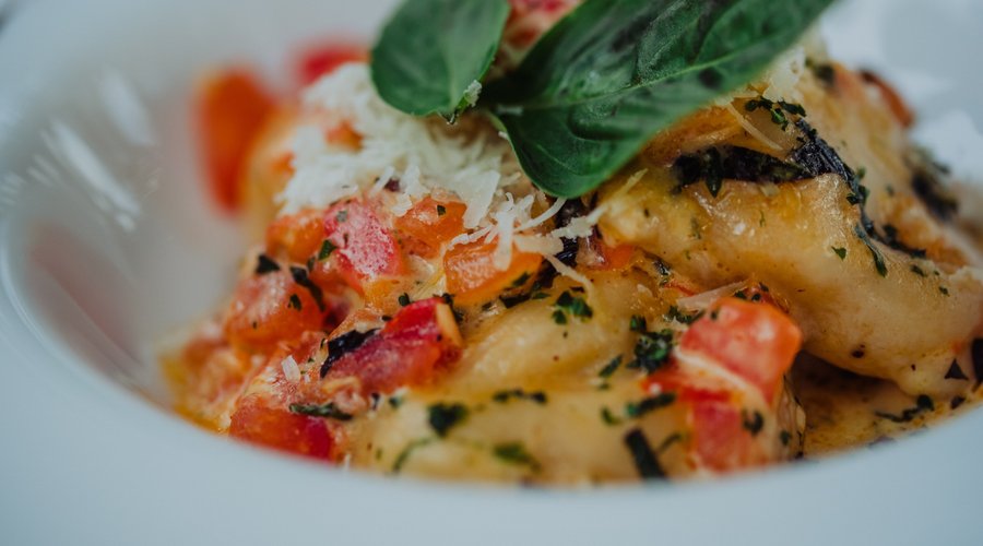 Lobster Ravioli:  Homemade ravioli, sautéed spinach, "sauce vierge", parmesan and basil cream, with white truffle oil